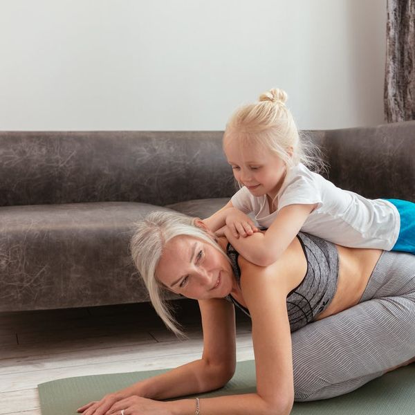 Person doing a stretching yoga pose on a mat.