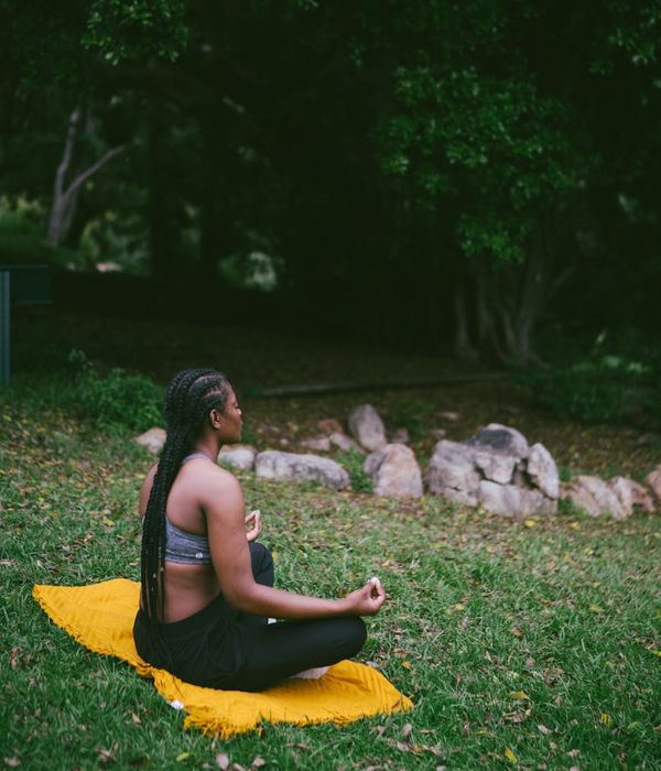 Woman meditating peacefully in a calm environment.